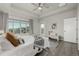 Bright bedroom with ceiling fan, neutral decor, and large window providing ample natural light at 1365 W 67Th Pl, Denver, CO 80221