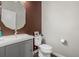 Modern powder room with sink, toilet, and stylish decor at 1365 W 67Th Pl, Denver, CO 80221