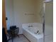 Bathroom featuring a large tub and separate shower at 7490 W Coal Mine Ave # A, Littleton, CO 80123