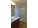 Standard bathroom with tiled shower and a wood-finished vanity at 7490 W Coal Mine Ave # A, Littleton, CO 80123