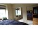Bright bedroom with slider mirror doors to the closet and a comfortable bed at 7490 W Coal Mine Ave # A, Littleton, CO 80123