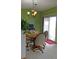 Comfortable dining area featuring a wood table, four chairs, and sliding glass doors at 7490 W Coal Mine Ave # A, Littleton, CO 80123