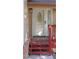 Close up of the front door with an oval glass design and a vibrant red porch at 7490 W Coal Mine Ave # A, Littleton, CO 80123