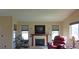 Bright living room boasts a fireplace, mounted TV, and large windows at 7490 W Coal Mine Ave # A, Littleton, CO 80123