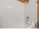 A bathroom featuring a bathtub with white tiles at 8199 Welby Rd # 3707, Denver, CO 80229