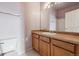 Bathroom features include wood cabinets, a white sink, and a mirror at 8199 Welby Rd # 3707, Denver, CO 80229