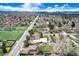 Expansive aerial view of a charming neighborhood with lush greenery and distant mountain views at 100 Balsam St, Lakewood, CO 80226