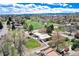 Overhead view of home near park with pond, showcasing the surrounding neighborhood and mountain views at 100 Balsam St, Lakewood, CO 80226