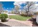 Well-maintained backyard featuring a stone path and a lush green lawn at 100 Balsam St, Lakewood, CO 80226