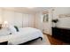 Bright bedroom with hardwood floors, a large closet, and a window at 100 Balsam St, Lakewood, CO 80226