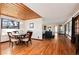 Cozy dining room featuring hardwood floors, a chandelier, and natural light from the window at 100 Balsam St, Lakewood, CO 80226
