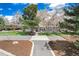 Expansive home featuring a well-manicured front yard, and a symmetrical walkway, complemented by lush trees at 100 Balsam St, Lakewood, CO 80226