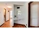 Hallway with built-in shelving, a vanity area, and access to the bedrooms and bathroom at 100 Balsam St, Lakewood, CO 80226