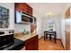 Kitchen featuring stainless microwave and granite countertops and a small table at 100 Balsam St, Lakewood, CO 80226