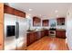 Bright kitchen featuring stainless steel appliances, granite countertops, and rich wood cabinets at 100 Balsam St, Lakewood, CO 80226
