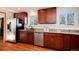 Kitchen featuring stainless appliances, granite countertops, and wood floors at 100 Balsam St, Lakewood, CO 80226