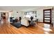 Bright living room featuring hardwood floors, modern decor, and a view of the front yard at 100 Balsam St, Lakewood, CO 80226