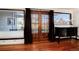 Bright living room with hardwood floors, window benches, and French doors to backyard at 100 Balsam St, Lakewood, CO 80226