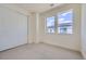 Neutral bedroom offers two windows, closet, and carpet creating a blank canvas for personalization and comfort at 682 Belay St, Erie, CO 80516