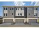 Contemporary townhome showcasing modern architecture, a two-car garage, and clean lines for a sleek curb appeal at 682 Belay St, Erie, CO 80516