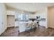 Modern kitchen with white cabinets, marble counters, an island with seating and stainless steel appliances at 682 Belay St, Erie, CO 80516