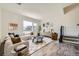 Bright living room features a plush white sofa, area rug, large window, and stylish decor for a cozy feel at 682 Belay St, Erie, CO 80516