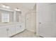 Clean, bright bathroom with double vanity, quartz countertop, and a glass-enclosed shower at 2212 Crosswind St, Fort Lupton, CO 80621