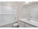 Neat, bright bathroom with white tiled tub and shower and a sleek vanity at 2212 Crosswind St, Fort Lupton, CO 80621