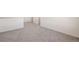 Neutral carpeted bedroom with staircase and natural light at 2212 Crosswind St, Fort Lupton, CO 80621