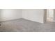 Spacious bedroom featuring new neutral gray carpeting and a doorway to the en suite at 2212 Crosswind St, Fort Lupton, CO 80621