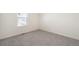 Cozy bedroom with neutral gray carpet and natural light from a window at 2212 Crosswind St, Fort Lupton, CO 80621