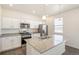 Open-concept kitchen boasts stainless steel appliances, granite counters, and ample cabinet space at 2212 Crosswind St, Fort Lupton, CO 80621