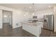 Contemporary kitchen with stainless appliances, island, and views to the living area at 2212 Crosswind St, Fort Lupton, CO 80621