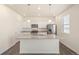 Modern kitchen with stainless appliances, a granite island, and white cabinetry at 2212 Crosswind St, Fort Lupton, CO 80621