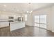 Bright kitchen features granite countertops, stainless appliances, and island with seating at 2212 Crosswind St, Fort Lupton, CO 80621
