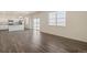 Open-concept living space featuring modern wood floors and neutral decor at 2212 Crosswind St, Fort Lupton, CO 80621