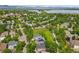 Beautiful aerial view of a well-maintained community with lush greenery, homes, and a tranquil lake in the distance at 5755 W Berry Ave, Denver, CO 80123