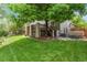 Expansive backyard featuring a well-manicured lawn, deck, and a luxurious hot tub for relaxation and enjoyment at 5755 W Berry Ave, Denver, CO 80123