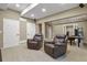 Spacious basement with soft carpet, neutral walls, two leather recliners, and ample room for relaxing at 5755 W Berry Ave, Denver, CO 80123