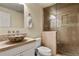 Bathroom featuring a vessel sink, granite countertop, and tile shower with glass door at 5755 W Berry Ave, Denver, CO 80123