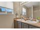 Bathroom featuring double sink vanity, large mirror, and natural light at 5755 W Berry Ave, Denver, CO 80123