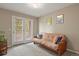 Comfortable bedroom with a futon, soft carpet, and a large glass door with access to an outdoor balcony at 5755 W Berry Ave, Denver, CO 80123
