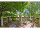 Inviting deck area with chairs, table, and lovely landscaping, perfect for outdoor relaxation and entertainment at 5755 W Berry Ave, Denver, CO 80123