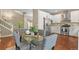Dining room open to kitchen, featuring stainless steel appliances and modern finishes at 5755 W Berry Ave, Denver, CO 80123