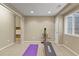 Home gym area featuring carpeted floors, natural light from a window, and workout equipment at 5755 W Berry Ave, Denver, CO 80123