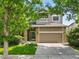 Charming two-story home with a well-maintained lawn, stone accents, and a convenient two-car garage at 5755 W Berry Ave, Denver, CO 80123