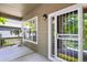 Covered front porch area with secure ornamental door and a decorative potted plant at 5755 W Berry Ave, Denver, CO 80123