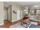 Hallway with neutral paint, hardwood floors, and a view of living room and kitchen at 5755 W Berry Ave, Denver, CO 80123