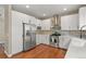 Spacious kitchen featuring white cabinets, stainless steel appliances, and a gas range at 5755 W Berry Ave, Denver, CO 80123