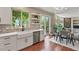 Open kitchen and dining area featuring white cabinets, stainless steel appliances, and sliding glass doors to the deck at 5755 W Berry Ave, Denver, CO 80123